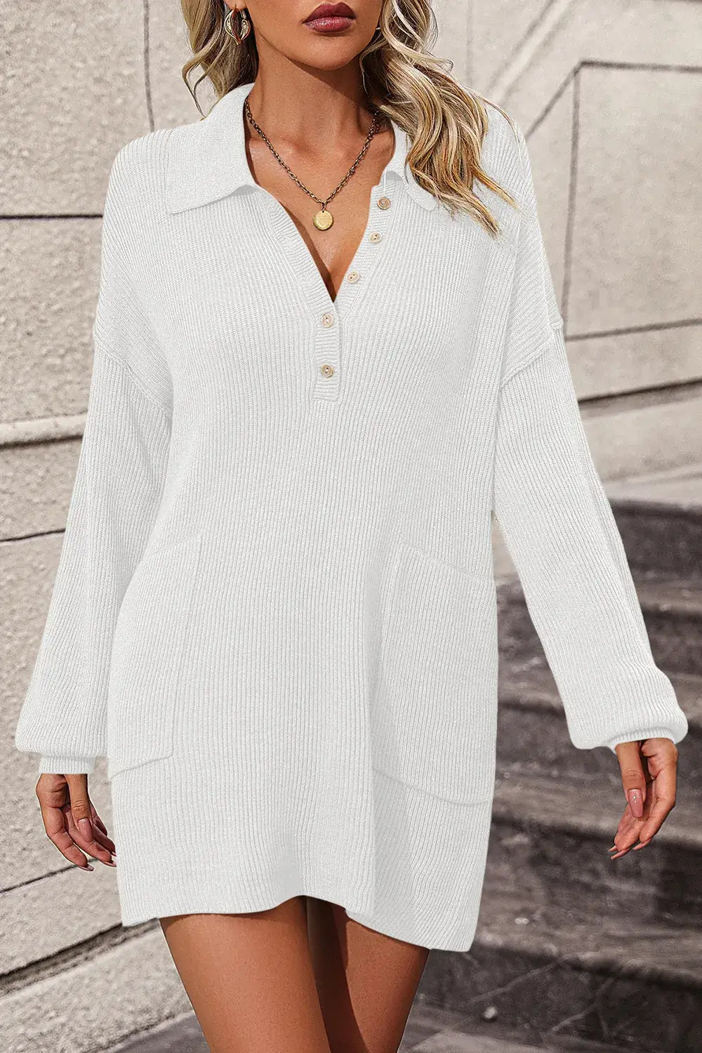 Woman wearing a white long-sleeve dress against a neutral background